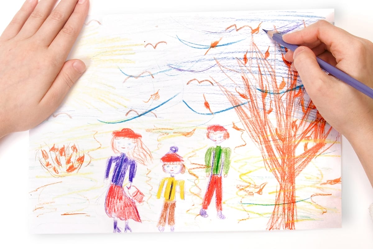 A child draws a family