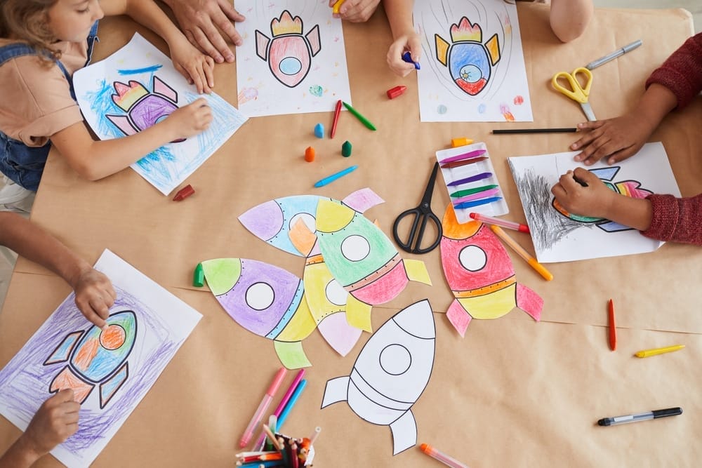 Group of kids coloring the same rocket drawing