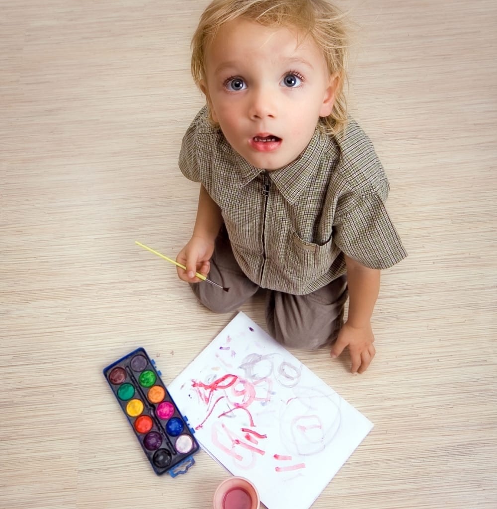 Surprised child stops drawing and looks up