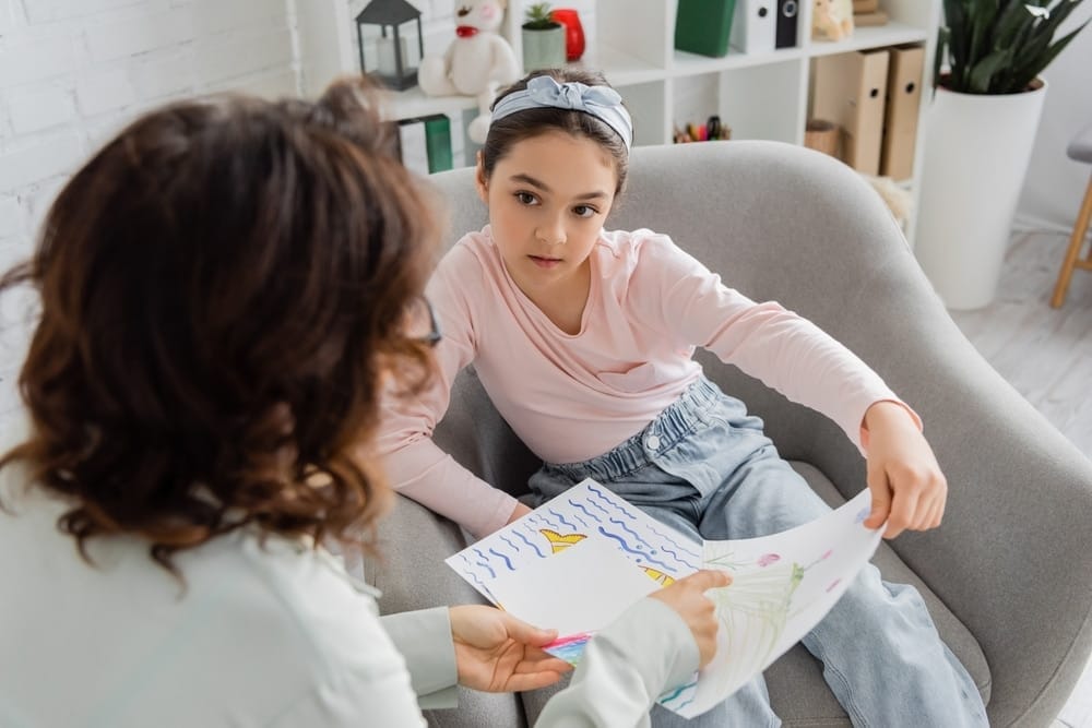 Adult pointing at kid drawing