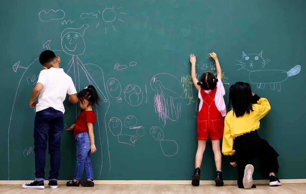 Children drawing in a blackboard