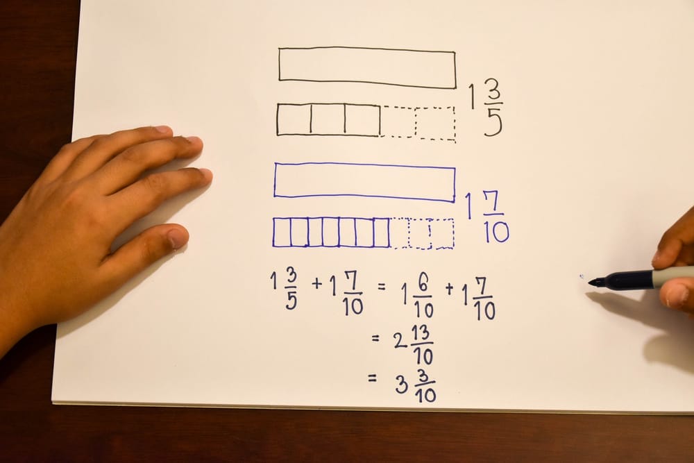 Kid solving fraction problem with drawing